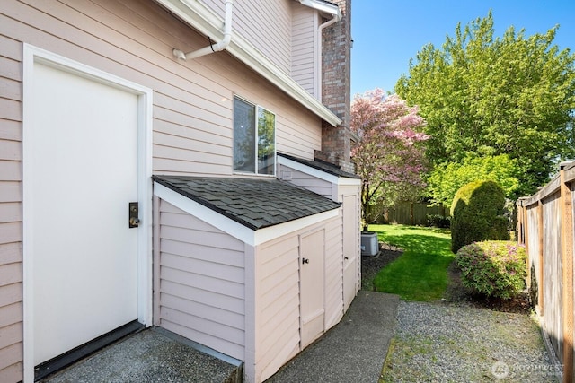 23812 21st Dr SE, Bothell, WA 98021 - view of property exterior with a lawn, roof with shingles, and fence