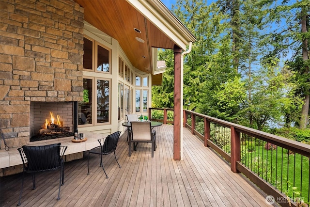 wooden terrace with a fireplace