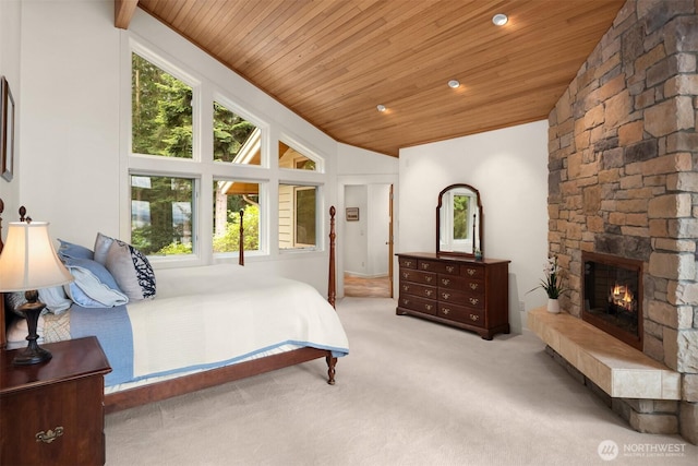 carpeted bedroom featuring wood ceiling, multiple windows, a stone fireplace, and lofted ceiling