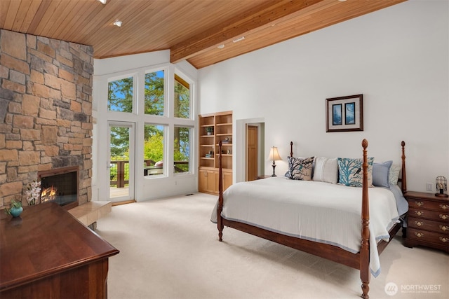 bedroom featuring access to outside, carpet, beam ceiling, and wooden ceiling