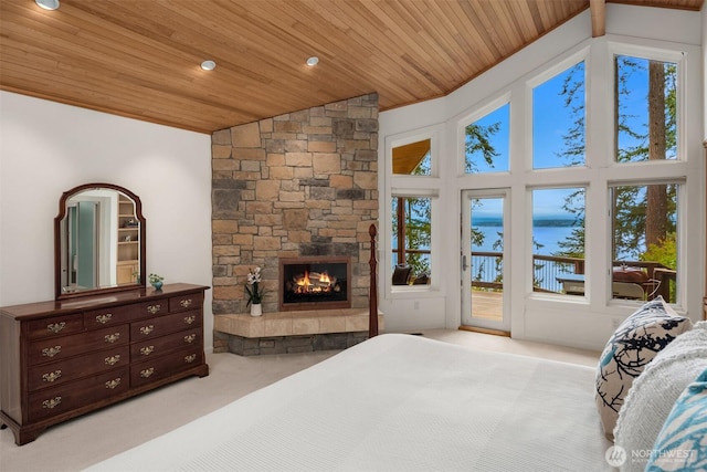 carpeted bedroom with access to outside, wooden ceiling, and multiple windows