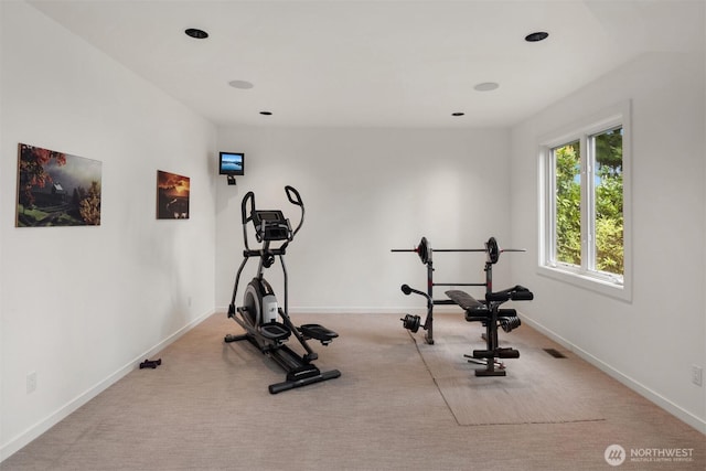 exercise area featuring carpet floors, baseboards, and visible vents