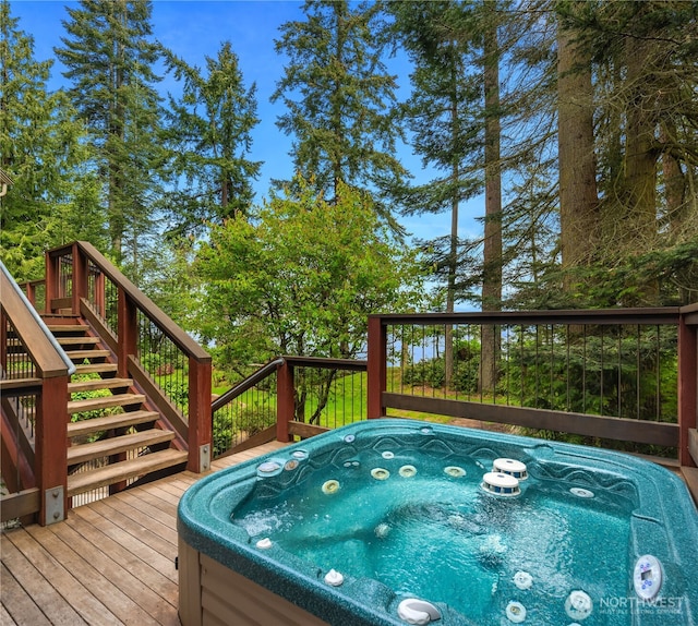 deck with stairs and an outdoor hot tub