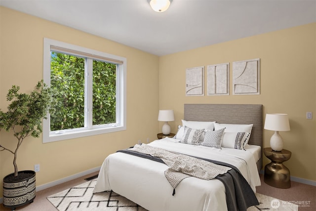 carpeted bedroom featuring baseboards
