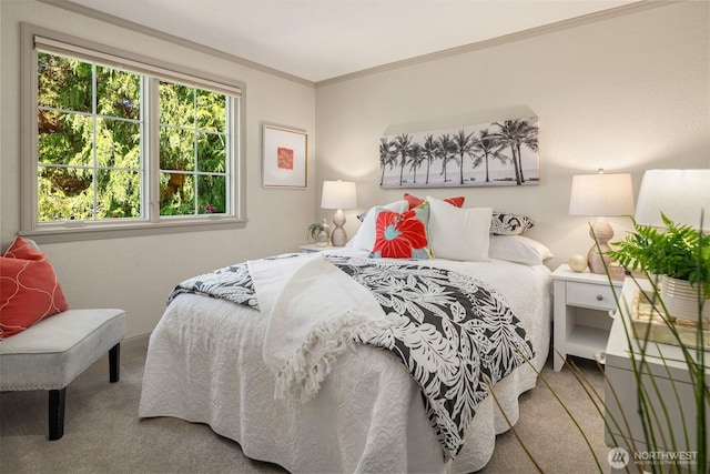 carpeted bedroom with ornamental molding