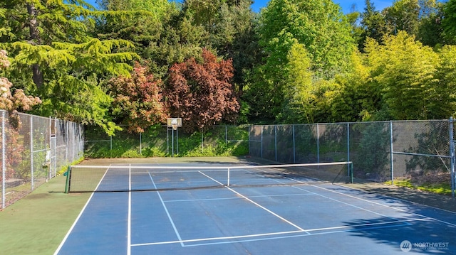 view of sport court featuring fence