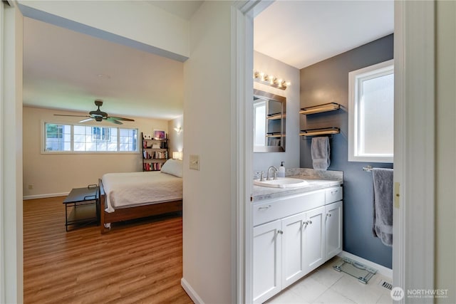 6160 NE 185th St, Kenmore, WA 98028 - bathroom with vanity, ceiling fan, baseboards, and wood finished floors