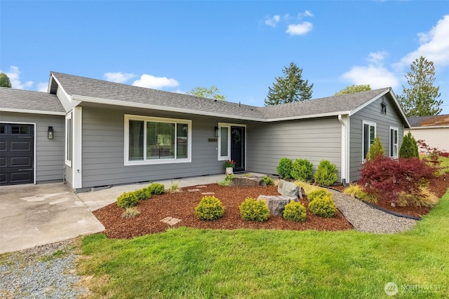 ranch-style house featuring an attached garage and a front yard