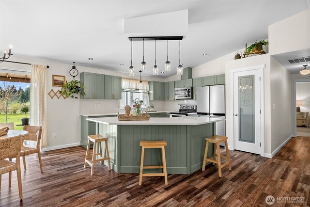 kitchen with dark wood-style flooring, appliances with stainless steel finishes, a wealth of natural light, and green cabinets