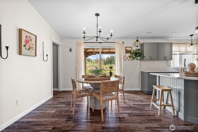 dining space with recessed lighting, baseboards, dark wood-style flooring, and a notable chandelier