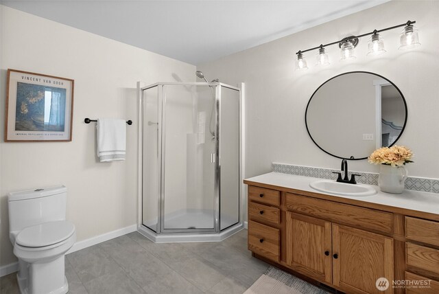 full bath with tile patterned flooring, a shower stall, vanity, baseboards, and toilet