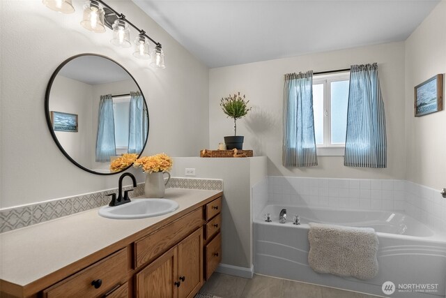 full bath featuring vanity, tile patterned flooring, and a garden tub