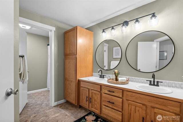 full bath with double vanity and a sink