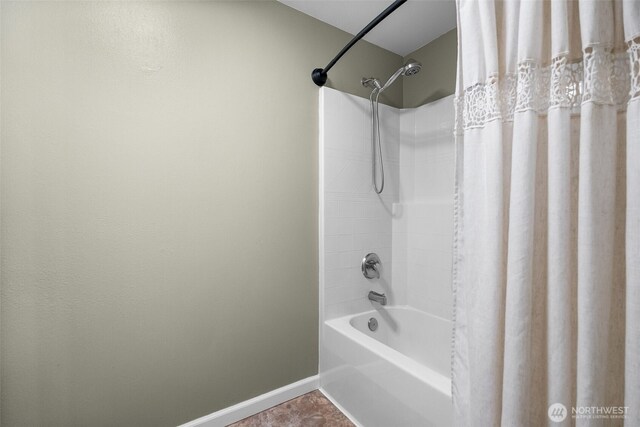 full bathroom featuring baseboards and shower / tub combo with curtain