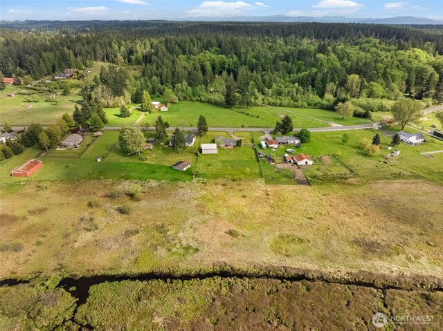drone / aerial view featuring a wooded view