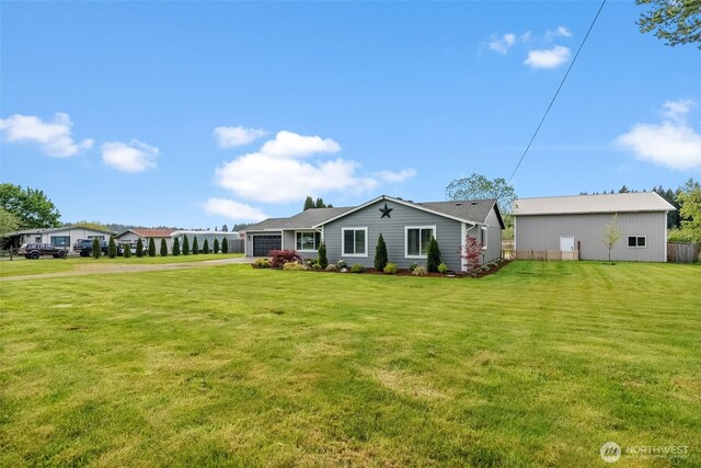 ranch-style home with concrete driveway, an attached garage, and a front lawn