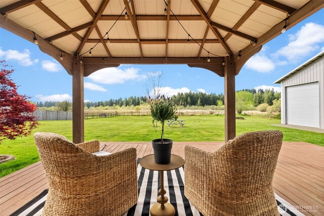 view of patio / terrace featuring a gazebo, a rural view, fence, and a deck