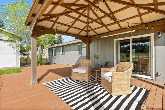 wooden deck with a gazebo and fence