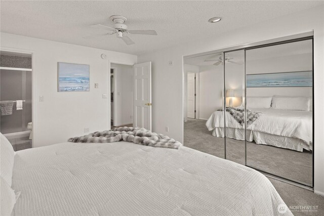 carpeted bedroom featuring a closet, baseboards, a ceiling fan, a textured ceiling, and connected bathroom