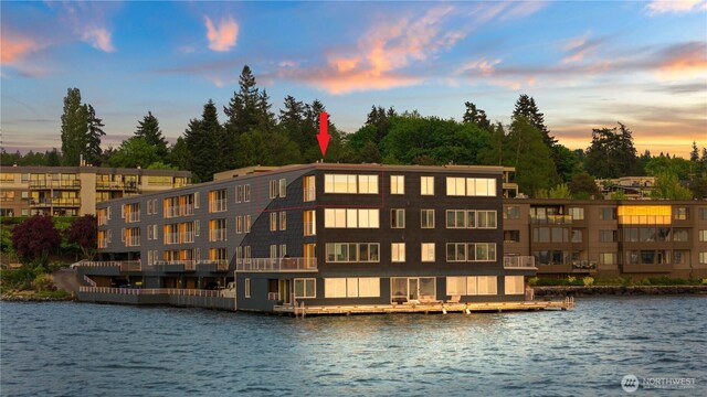 water view featuring a boat dock and a tree filled landscape