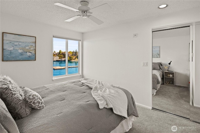 733 S Lake St Unit 312, Kirkland, WA 98033 - carpeted bedroom with a textured ceiling, a ceiling fan, and baseboards