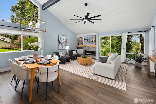 6540 159th Ave NE, Redmond, WA 98052 - dining area featuring wood finished floors, a healthy amount of sunlight, high vaulted ceiling, a lit fireplace, and ceiling fan with notable chandelier