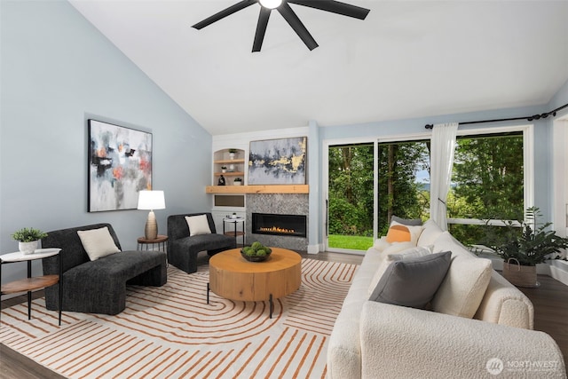 6540 159th Ave NE, Redmond, WA 98052 - living area featuring a glass covered fireplace, lofted ceiling, wood finished floors, ceiling fan, and built in shelves