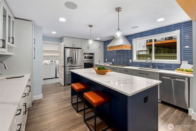 6540 159th Ave NE, Redmond, WA 98052 - kitchen with a sink, custom exhaust hood, stainless steel appliances, and washer and clothes dryer