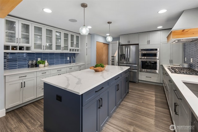 6540 159th Ave NE, Redmond, WA 98052 - kitchen featuring decorative backsplash, appliances with stainless steel finishes, a center island, a sink, and custom range hood