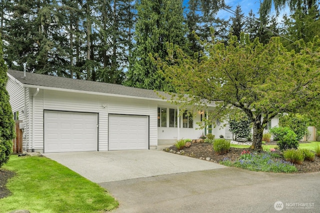 single story home with a garage and driveway