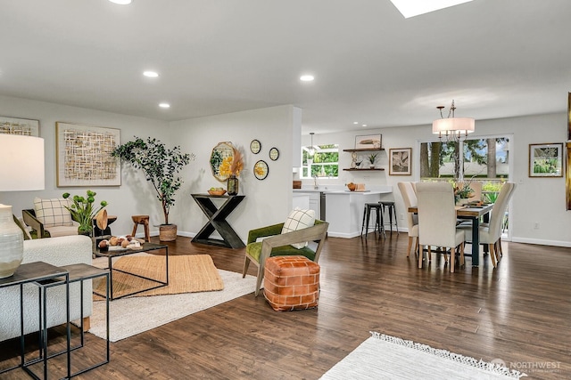 living room with recessed lighting, baseboards, and wood finished floors
