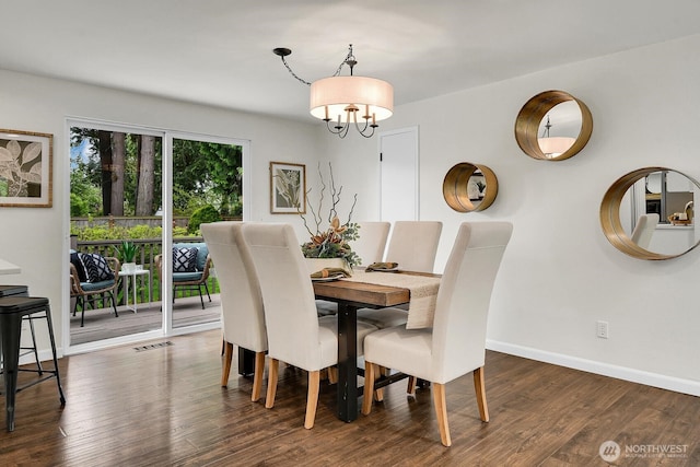 dining room with baseboards, a notable chandelier, dark wood-style flooring, and visible vents