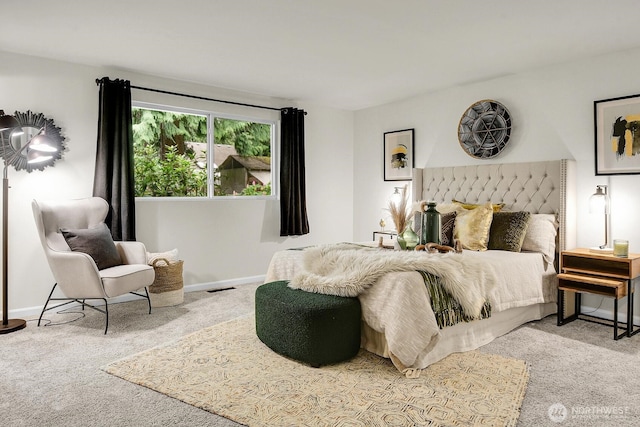 carpeted bedroom featuring baseboards and visible vents
