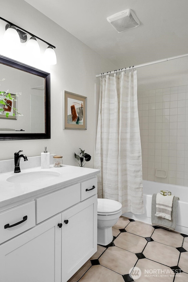 bathroom with toilet, visible vents, shower / tub combo, and vanity