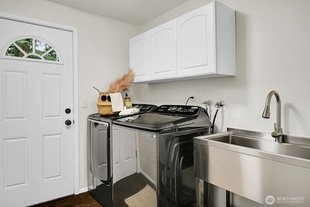 washroom featuring washer and dryer, dark wood-style floors, a sink, and cabinet space