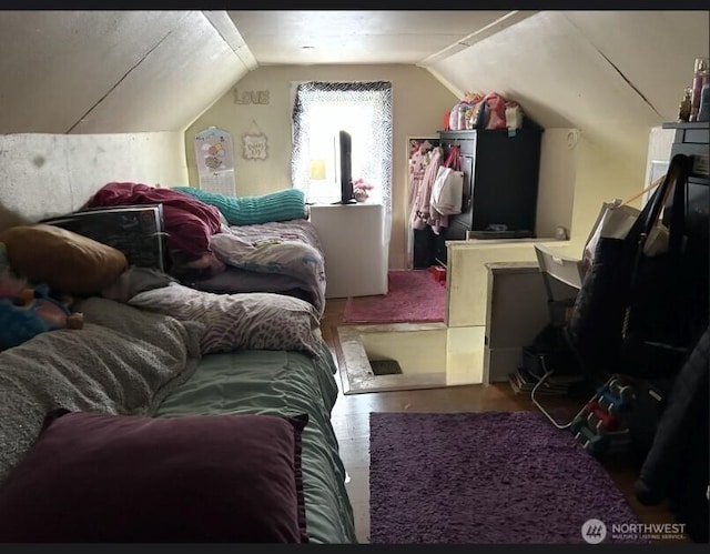 bedroom with lofted ceiling