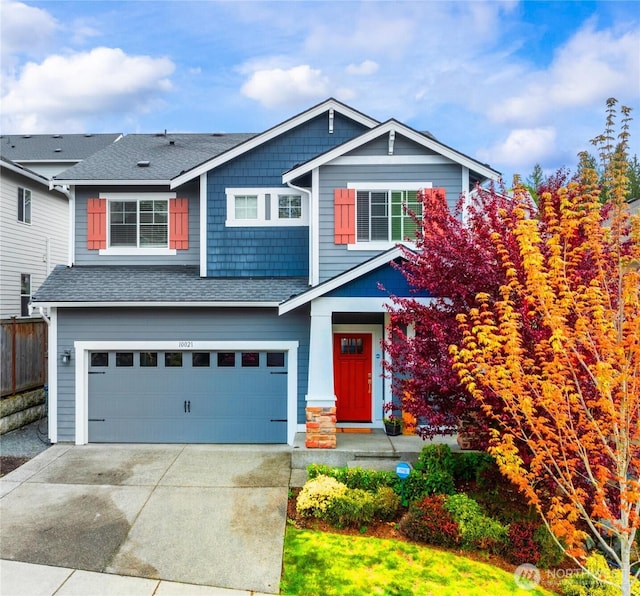 10021 14th Pl SE, Lake Stevens, WA 98258 - craftsman-style house featuring an attached garage, driveway, fence, and a shingled roof