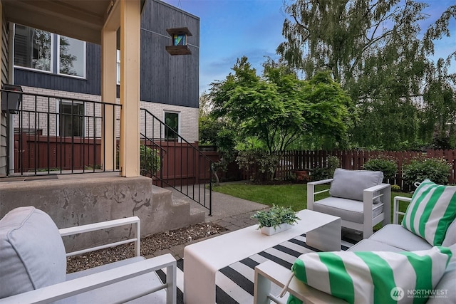 view of patio featuring an outdoor living space and fence