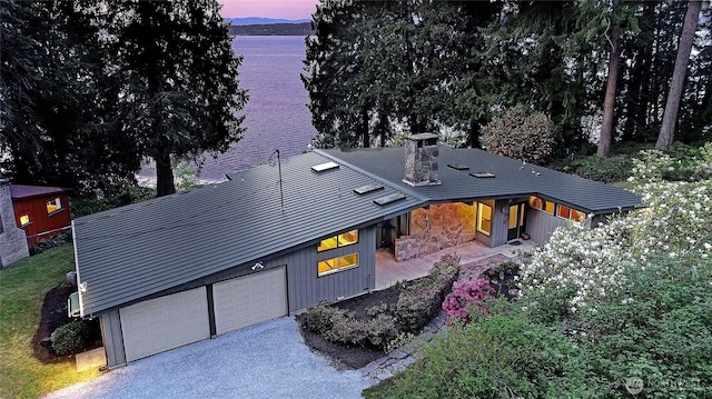 1357 Steffen Pl, Camano Island, WA 98282 - view of front of house featuring an attached garage, a water view, and driveway