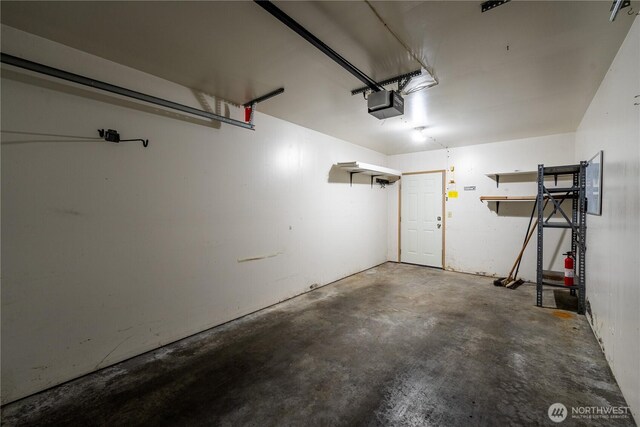 garage featuring a garage door opener and electric panel