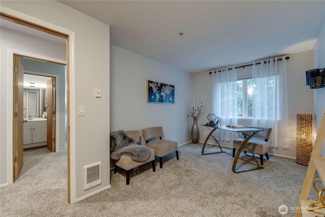 home office featuring baseboards, light colored carpet, and visible vents