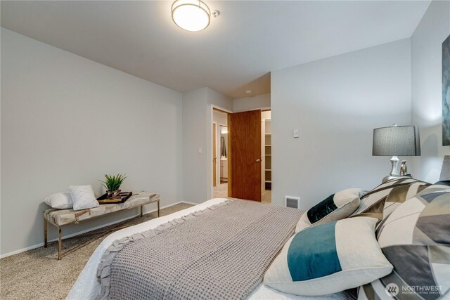 carpeted bedroom featuring visible vents and baseboards