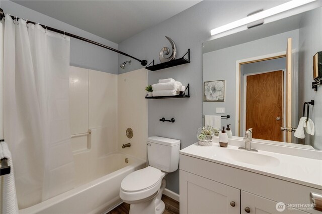 bathroom featuring vanity, wood finished floors, shower / bath combination with curtain, and toilet