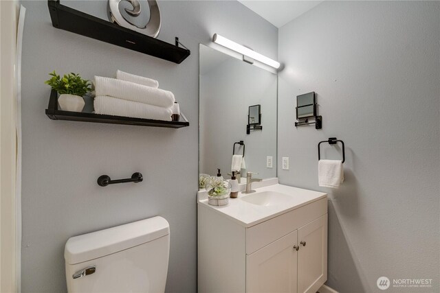 bathroom with toilet and vanity