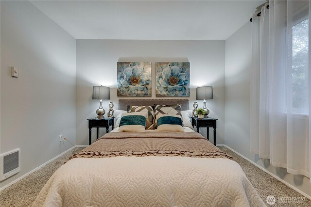 carpeted bedroom featuring baseboards and visible vents
