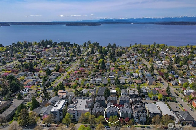aerial view with a water and mountain view and a residential view