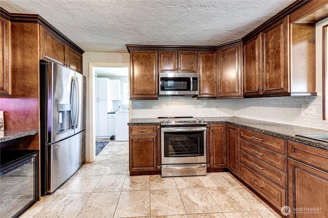 kitchen featuring backsplash, appliances with stainless steel finishes, dark stone counters, and wine cooler
