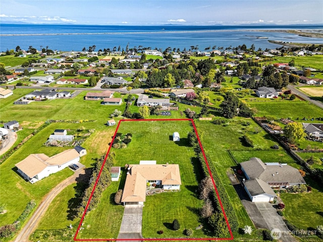 drone / aerial view featuring a water view and a residential view