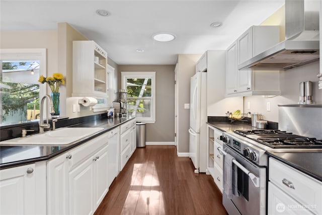 15825 10th Ave SW, Burien, WA 98166 - kitchen with wall chimney exhaust hood, freestanding refrigerator, gas range, a sink, and dark countertops