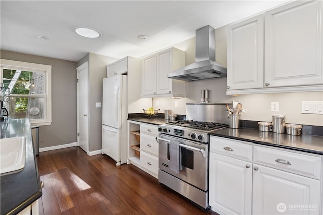 15825 10th Ave SW, Burien, WA 98166 - kitchen with wall chimney exhaust hood, freestanding refrigerator, stainless steel range with gas stovetop, and dark countertops